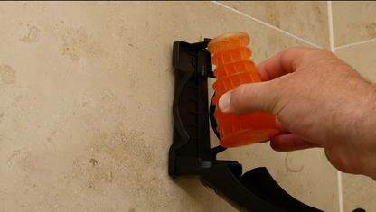 Image of a orange (Mango) Eco Air refill being installed into an Eco Air dispenser fixed to a wall