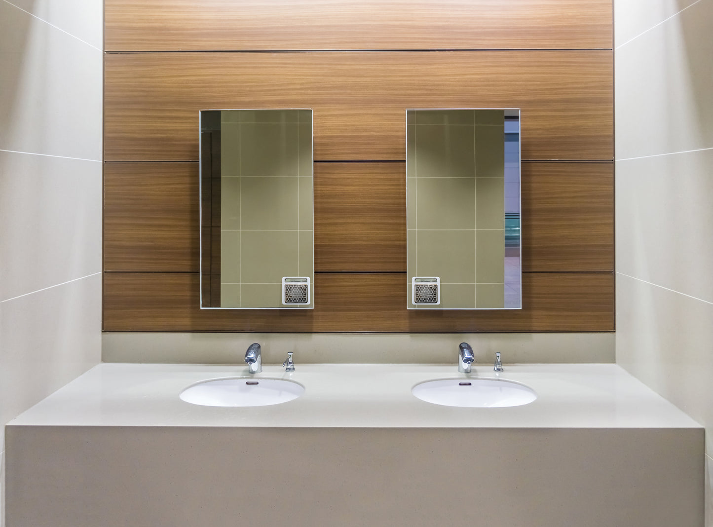 An image showing Two MyFresh units installed on vanity mirrors over a washroom sink