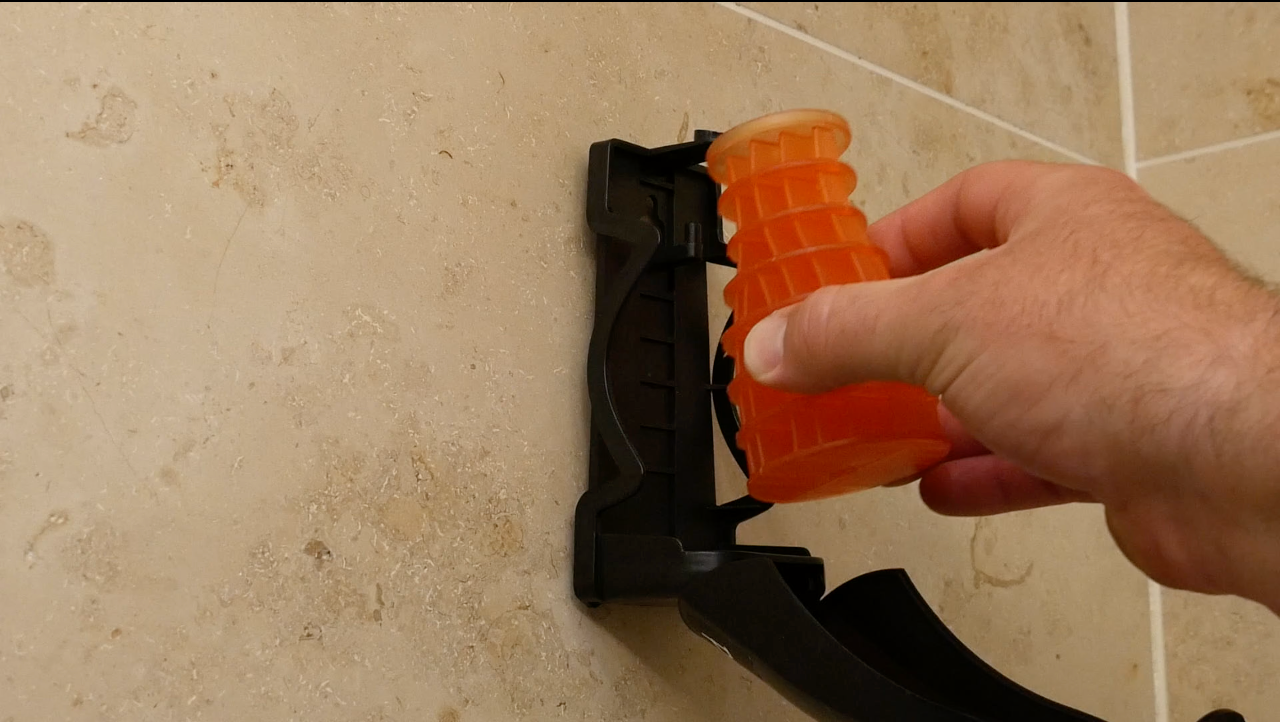 Image of a orange (Mango) Eco Air refill being installed into an Eco Air dispenser fixed to a wall