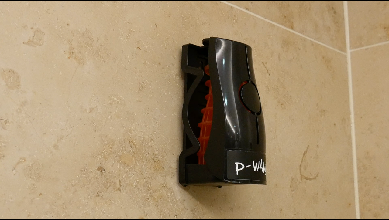 Image showing a black P-Wave Eco Air dispenser and refill installed on a wall