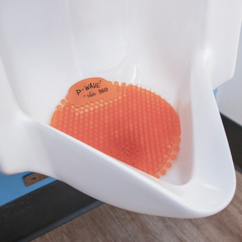 A side view of a Mango P-Wave 360 urinal screen in a white urinal